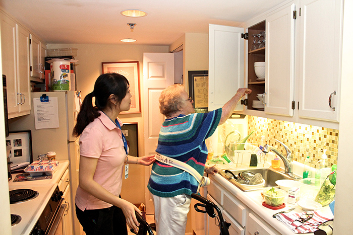 Occupational therapist helping a patient with daily living skills at home